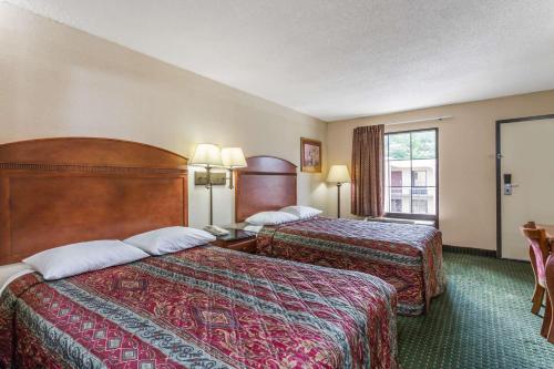 a hotel room with two beds and a window at Days Inn by Wyndham Camp Springs Andrews AFB in Camp Springs