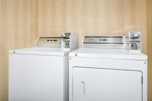 two machines sitting next to each other in a room at Super 8 by Wyndham Bentonville in Bentonville