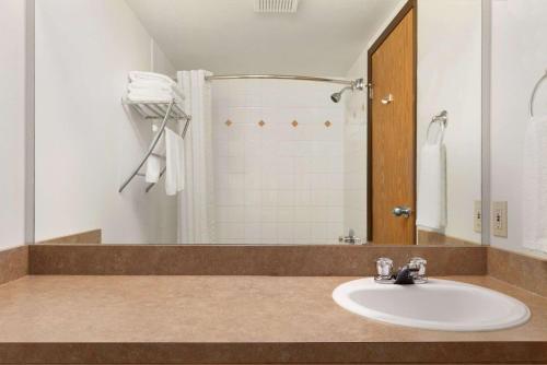 a bathroom with a sink and a shower at Super 8 by Wyndham Yellowknife in Yellowknife