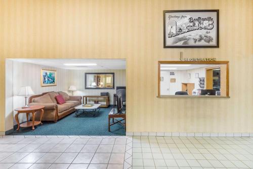 a living room with a couch and a table at Super 8 by Wyndham Bentonville in Bentonville