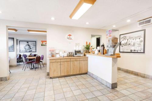 a waiting room with a counter and a restaurant at Super 8 by Wyndham Grand Junction Colorado in Grand Junction