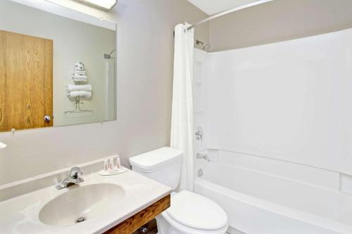 a white bathroom with a sink and a toilet at Super 8 by Wyndham Mokena/Frankfort /I-80 in Mokena