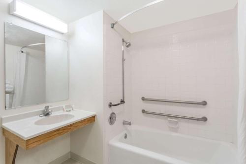 a white bathroom with a sink and a mirror at Super 8 by Wyndham Rexburg in Rexburg