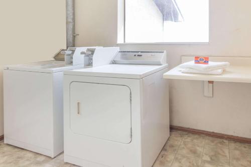 a kitchen with a washer and dryer on a counter at Super 8 by Wyndham Morris in Morris