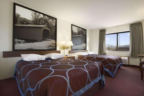 a hotel room with two beds and two windows at Super 8 by Wyndham Danville in Danville