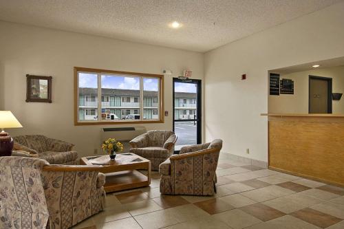a living room with a couch and chairs and a table at Super 8 by Wyndham Pendleton in Pendleton