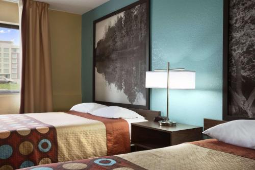 a hotel room with two beds and a window at Super 8 by Wyndham Mount Vernon, IL in Mount Vernon