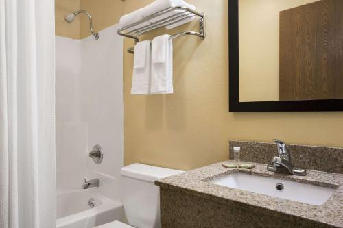a bathroom with a sink and a toilet at Super 8 by Wyndham Mattoon in Mattoon