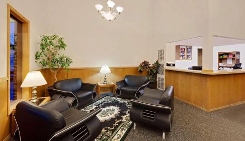 a waiting room with leather chairs and a waiting table at Super 8 by Wyndham Fayetteville in Fayetteville