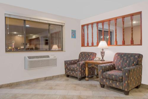 a waiting room with two chairs and a table at Super 8 by Wyndham Winnemucca NV in Winnemucca