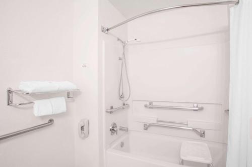 a bathroom with a shower and a toilet at Super 8 by Wyndham Winnemucca NV in Winnemucca