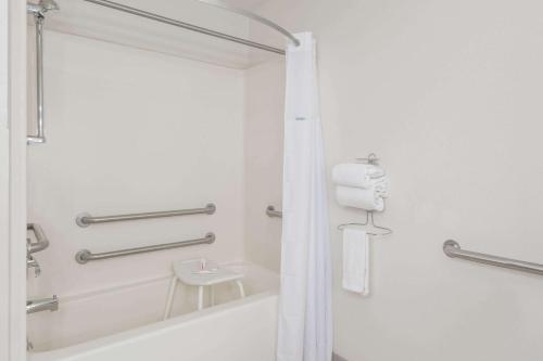 a white bathroom with a shower and a sink at Hotel Zyva in Beaver