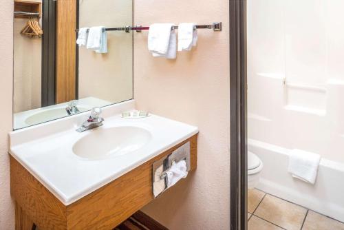 a bathroom with a sink and a toilet at Super 8 by Wyndham Blair in Blair