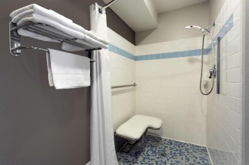 a bathroom with a shower and a toilet at Super 8 by Wyndham Fortuna in Fortuna