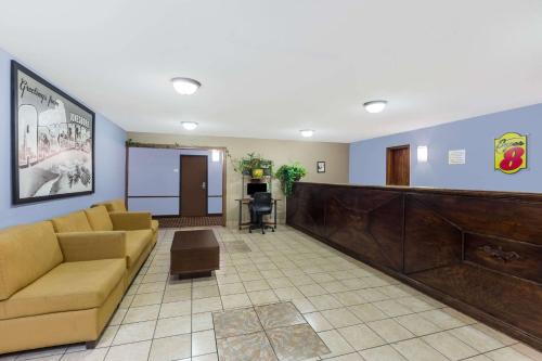 a lobby with a waiting room with couches and a waiting room at Super 8 by Wyndham Jonesboro in Jonesboro