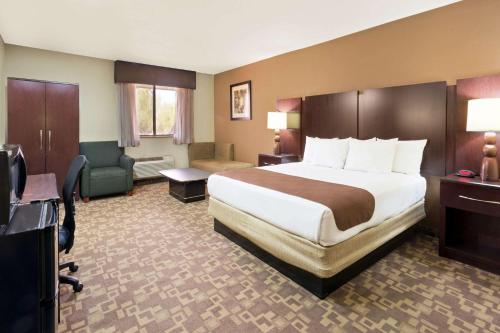 a hotel room with a bed and a desk at Super 8 by Wyndham Chandler Phoenix in Chandler