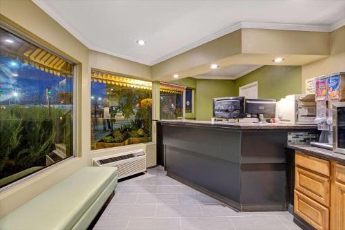 a restaurant with a counter and a food at Super 8 by Wyndham Santa Cruz Beach Boardwalk in Santa Cruz
