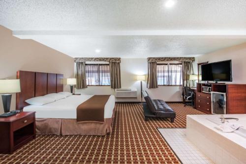 A television and/or entertainment centre at Super 8 by Wyndham Harlingen TX