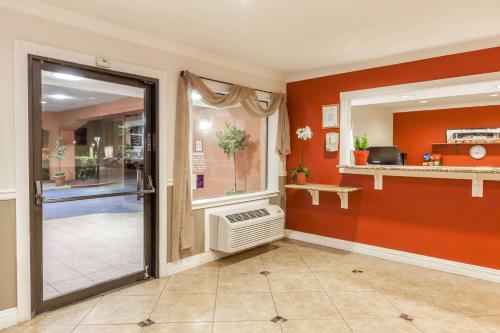 a hallway with a door leading to a room at Super 8 by Wyndham Bakersfield/Central in Bakersfield