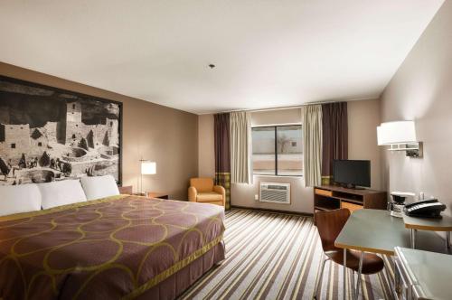 a hotel room with a bed and a desk at Super 8 by Wyndham Durango in Durango