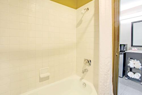 een badkamer met een bad en een douchecabine bij Super 8 by Wyndham Fort Collins in Fort Collins