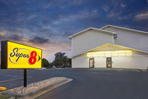 a sign in a parking lot in front of a store at Super 8 by Wyndham Columbus Airport in Columbus