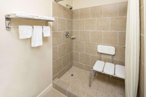 a bathroom with a shower with a toilet at Super 8 by Wyndham Burlington NC in Burlington