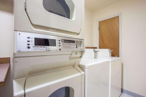a washer and dryer in a kitchen with a microwave at Super 8 by Wyndham Butte MT in Butte