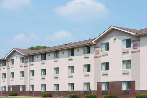 a large white building with windows at Super 8 by Wyndham New Castle in New Castle