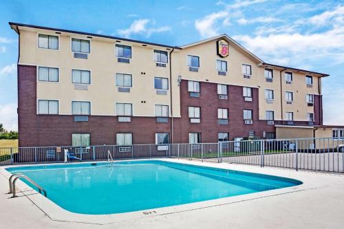 a hotel with a pool in front of a building at Super 8 by Wyndham Nashville/ Dntn/ Opryland Area in Nashville