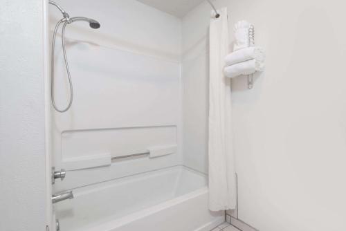 a bathroom with a shower and a bathtub at Super 8 by Wyndham Bernalillo in Bernalillo