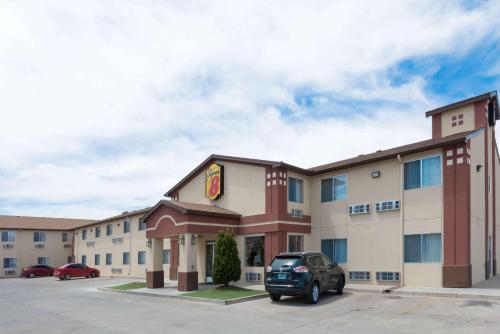 a hotel with a car parked in a parking lot at Super 8 by Wyndham Bernalillo in Bernalillo