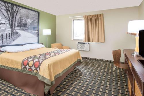 A bed or beds in a room at Super 8 by Wyndham Youngstown/Austintown