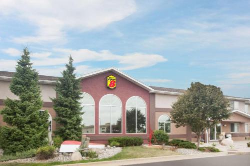a building with a sign on the front of it at Super 8 by Wyndham West Branch in West Branch