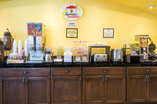a counter with food items on top of it at Super 8 by Wyndham Colby in Colby