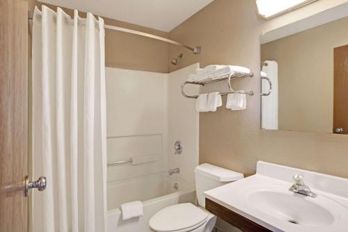 a bathroom with a sink and a toilet and a mirror at Super 8 by Wyndham Nashville/ Dntn/ Opryland Area in Nashville