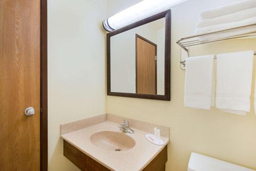 a bathroom with a sink and a mirror at Super 8 by Wyndham Ripley in Ripley