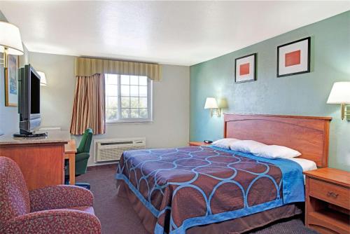 A bed or beds in a room at Super 8 by Wyndham Sacramento/Florin Rd