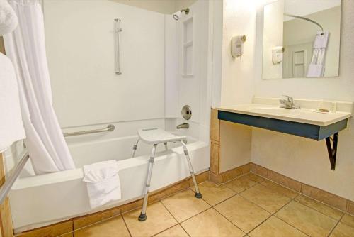 a bathroom with a sink and a bath tub and a sink at Super 8 by Wyndham Las Cruces University Area in Las Cruces