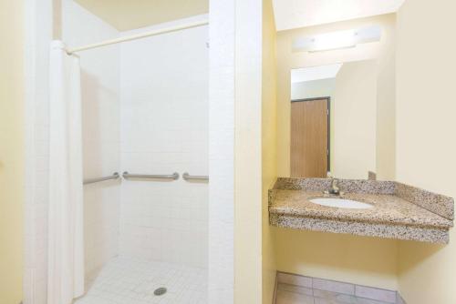 a bathroom with a sink and a shower at Super 8 by Wyndham Moriarty in Moriarty