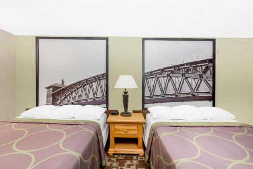 a hotel room with two beds and a bridge at Super 8 by Wyndham Kearney in Kearney