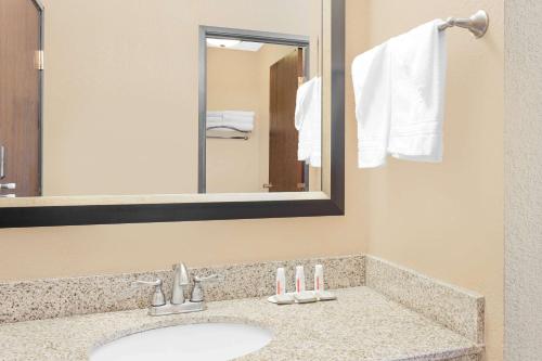 a bathroom with a sink and a mirror at Super 8 by Wyndham Sheboygan WI in Sheboygan