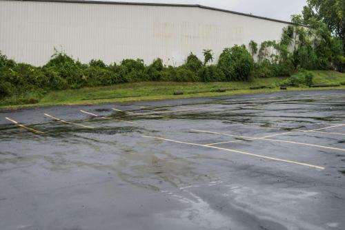 an empty parking lot with water on the ground at Super 8 by Wyndham Hartford in Hartford