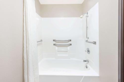 a bathroom with a white tub and a shower stall at Super 8 by Wyndham Paris IL in Paris