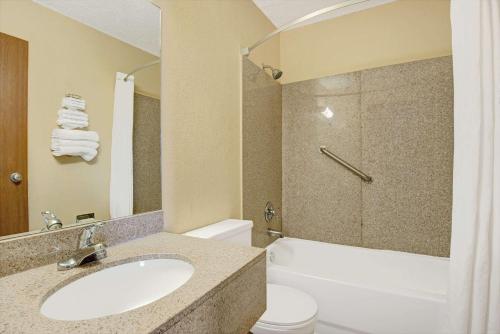 a bathroom with a sink and a toilet at Super 8 by Wyndham Independence Kansas City in Independence