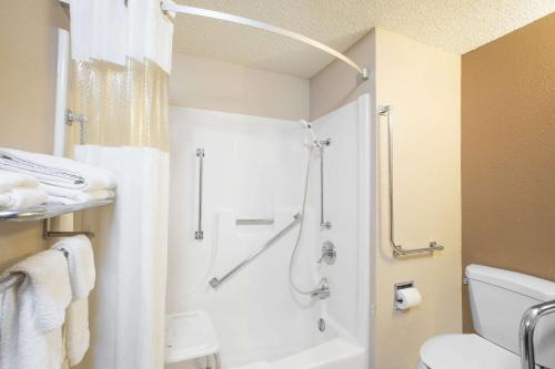 a bathroom with a shower and a toilet at Super 8 by Wyndham Sioux City/Morningside Area in Sioux City