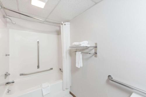 a bathroom with a shower and a bath tub at Super 8 by Wyndham Osceola IA in Osceola