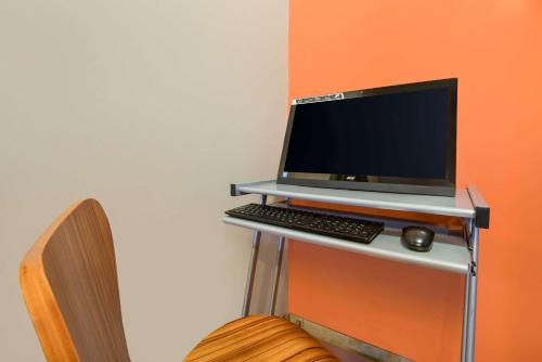 a laptop computer sitting on a desk with a keyboard at Super 8 by Wyndham Pella in Pella