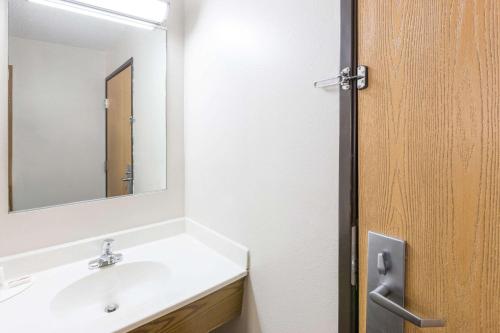 a bathroom with a white sink and a mirror at Super 8 by Wyndham Osceola IA in Osceola