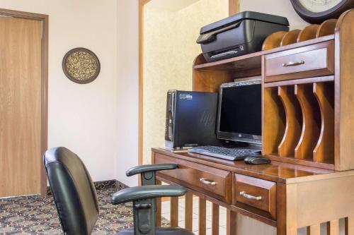 a desk with a computer on top of it at Super 8 by Wyndham Dodgeville in Dodgeville